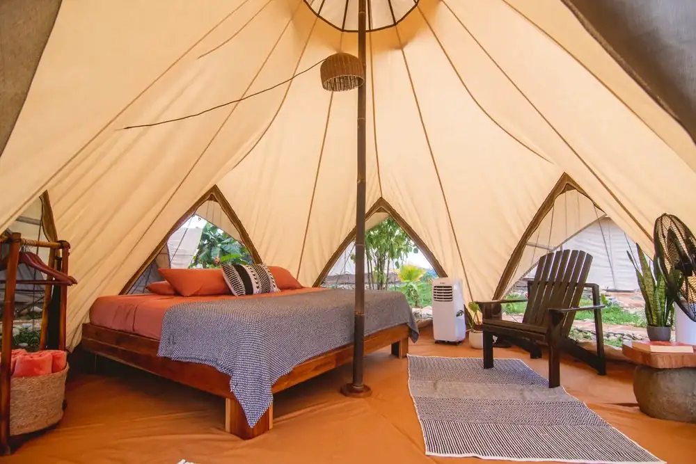 King bed glamping tent interior with air conditioning