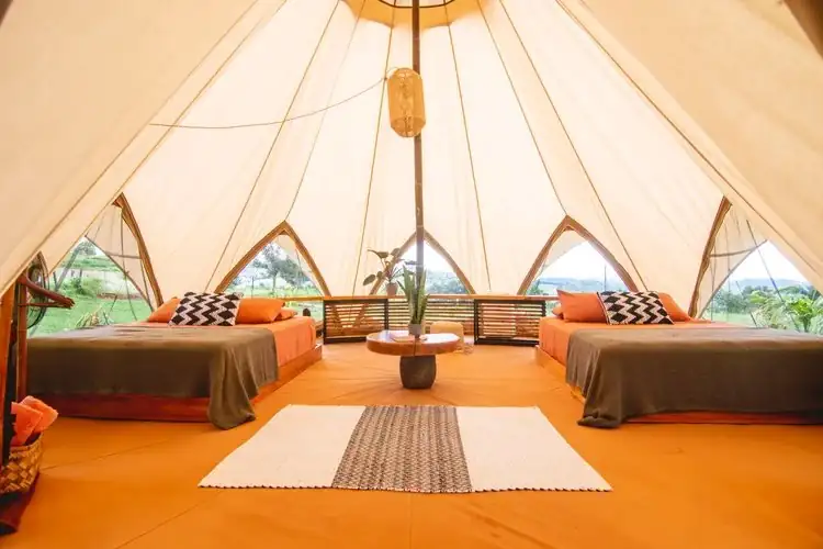 Glamping tent interior with two queen beds